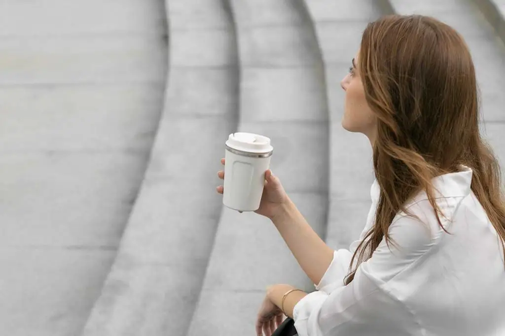 Woman drinking coffee on steps