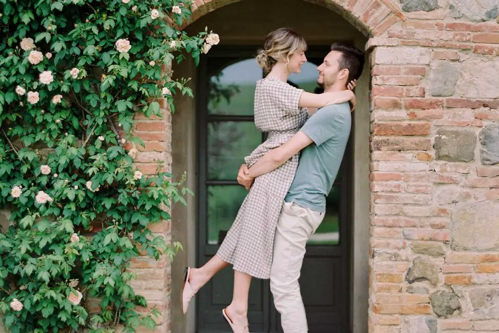Man picking woman up and smiling