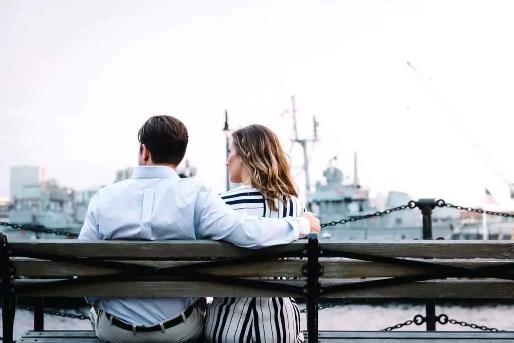 Couple sitting on bench outside