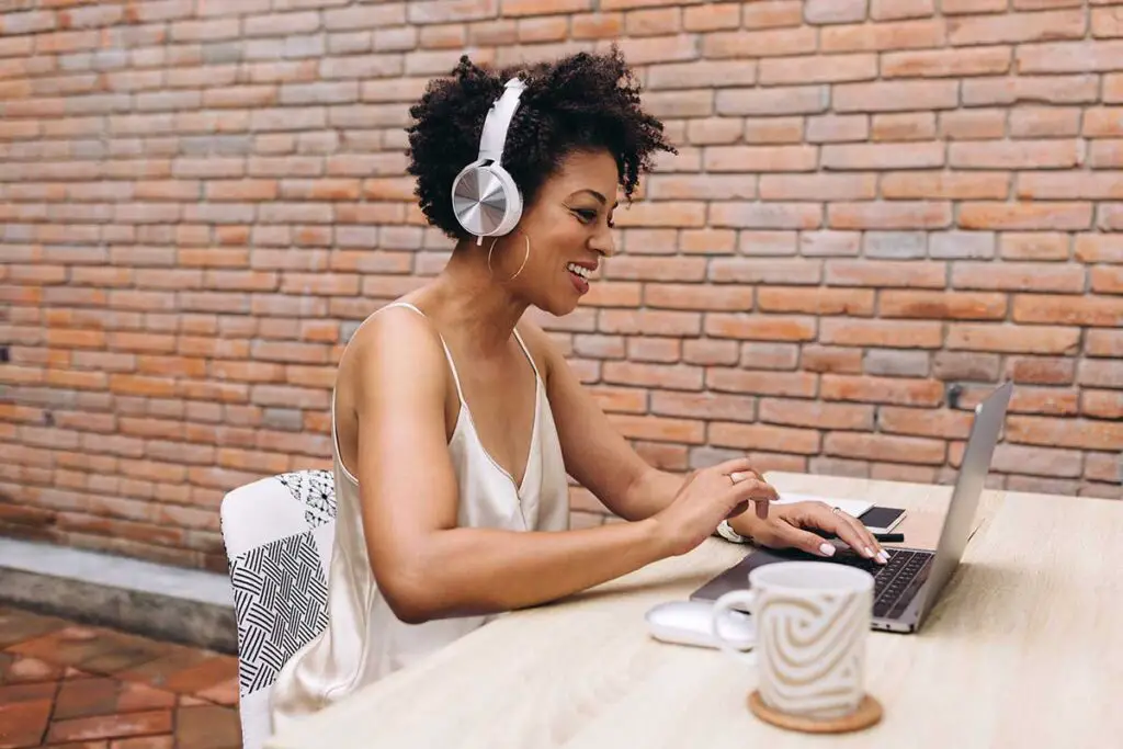 Woman listening to podcast at desk