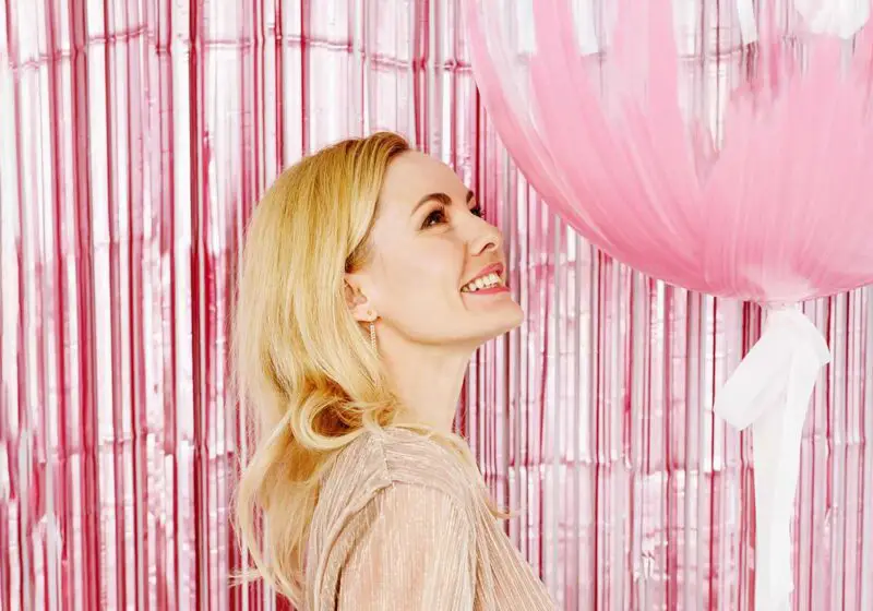 Woman smiling with birthday balloon