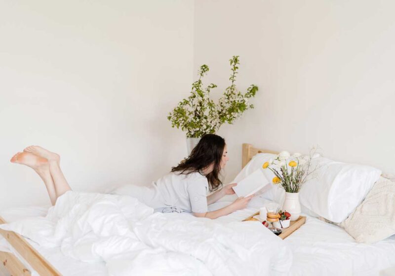 woman reading alone in bed