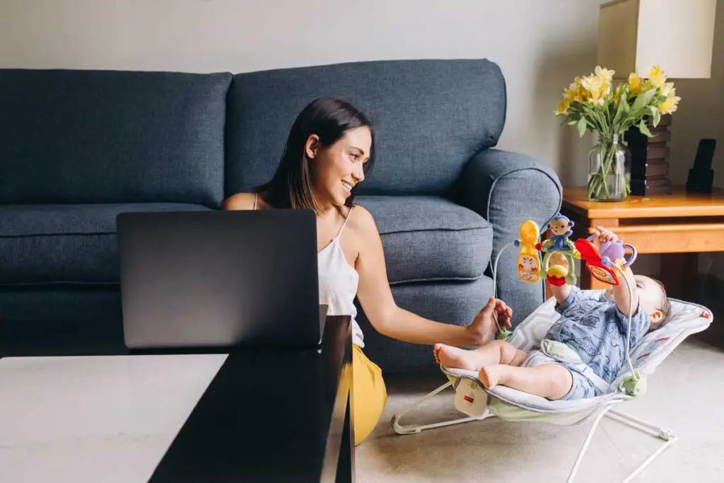 Mom on laptop with young child